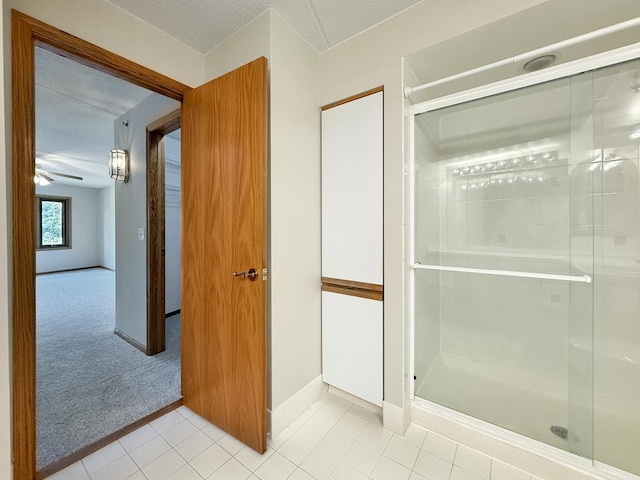 7120 N Milwaukee Ave Unit 305, Niles, IL 60714 - bathroom featuring a stall shower, tile patterned flooring, and a textured ceiling