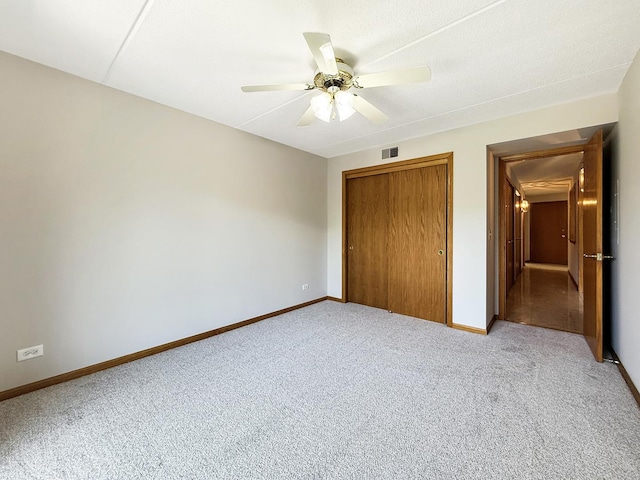 7120 N Milwaukee Ave Unit 305, Niles, IL 60714 - unfurnished bedroom with carpet, a closet, attic access, and ceiling fan