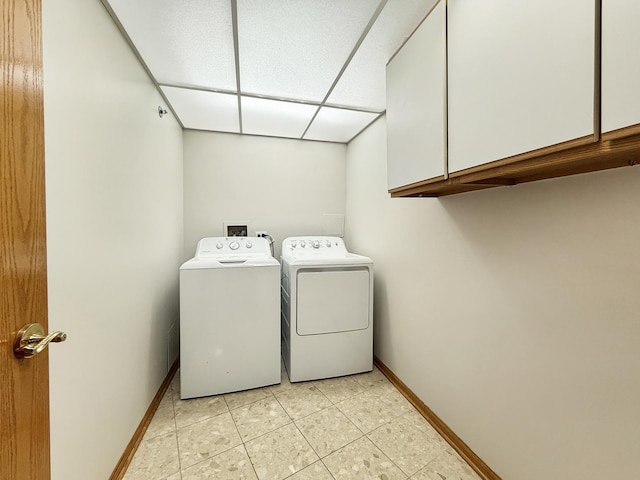 7120 N Milwaukee Ave Unit 305, Niles, IL 60714 - laundry area with cabinet space, washing machine and dryer, and light tile patterned floors