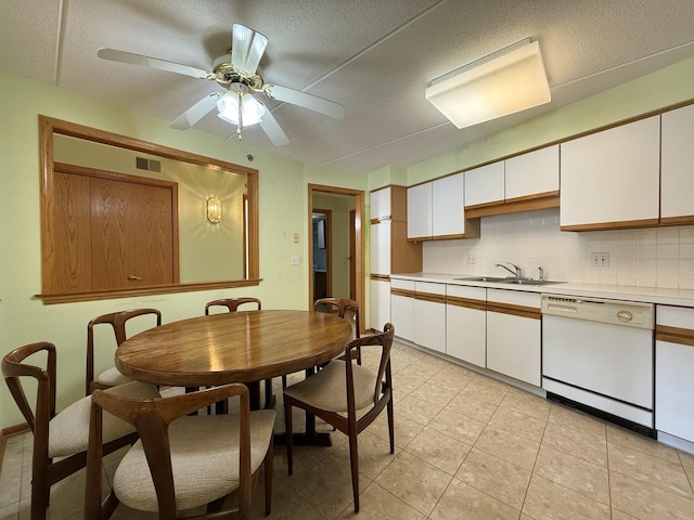 7120 N Milwaukee Ave Unit 305, Niles, IL 60714 - kitchen with tasteful backsplash, white cabinetry, dishwasher, light countertops, and a sink