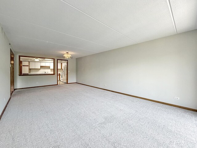 7120 N Milwaukee Ave Unit 305, Niles, IL 60714 - spare room featuring light colored carpet and a textured ceiling
