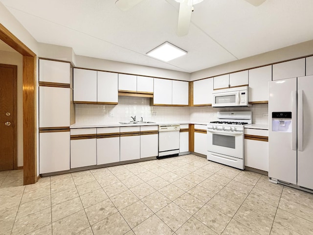 7120 N Milwaukee Ave Unit 305, Niles, IL 60714 - kitchen featuring white appliances, light countertops, tasteful backsplash, and white cabinets