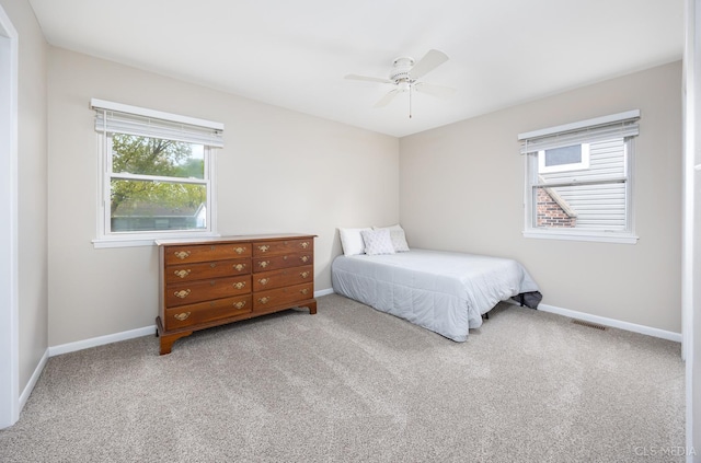 carpeted bedroom with baseboards and ceiling fan