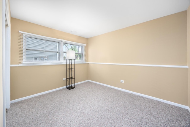 carpeted spare room with baseboards
