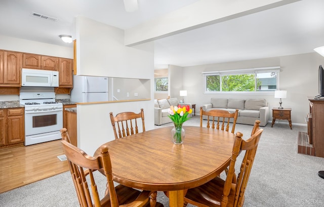dining room with light carpet