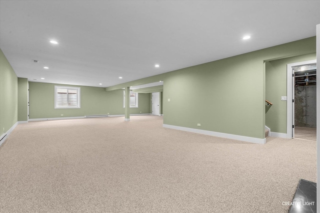 below grade area with baseboard heating, recessed lighting, and light colored carpet