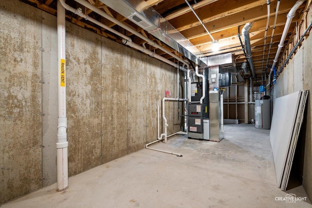 unfinished basement with water heater, visible vents, and heating unit