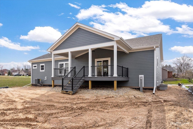 view of front of home featuring a shingled roof and cooling unit