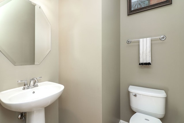 half bath featuring a sink and toilet