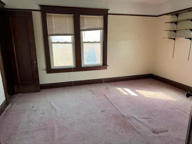 empty room featuring carpet floors and baseboards