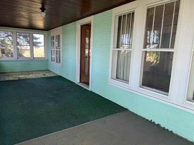 unfurnished sunroom with carpet