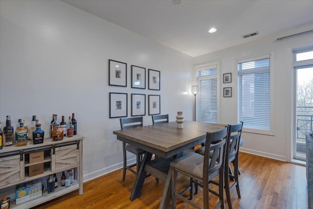 dining space featuring wood finished floors, baseboards, visible vents, and recessed lighting