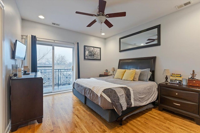 bedroom with light wood-style floors, recessed lighting, visible vents, and access to exterior