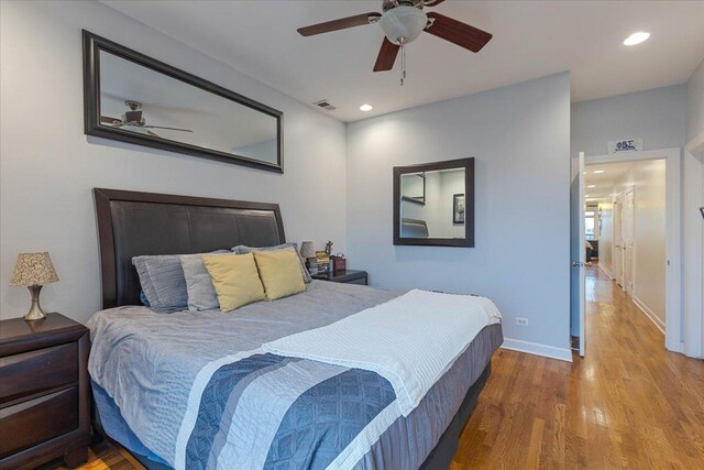 bedroom with a ceiling fan, visible vents, recessed lighting, wood finished floors, and baseboards