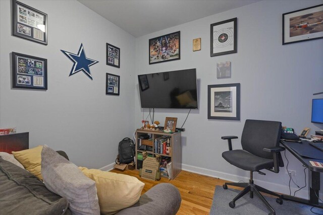 office space with baseboards and wood finished floors