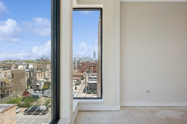 interior space featuring baseboards and a city view