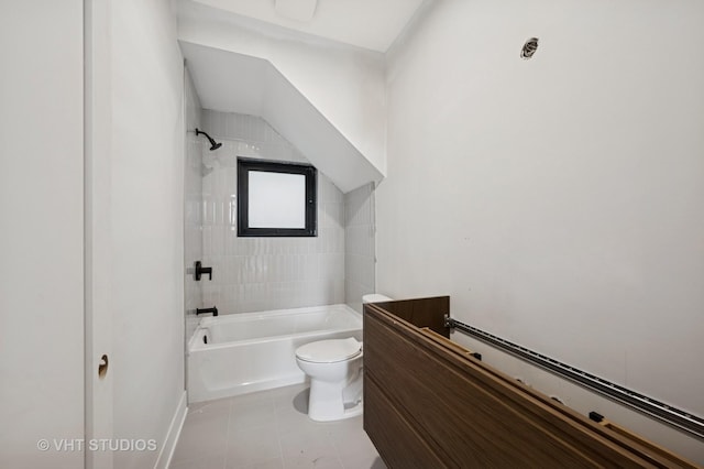 bathroom featuring toilet, tile patterned floors, washtub / shower combination, and baseboards