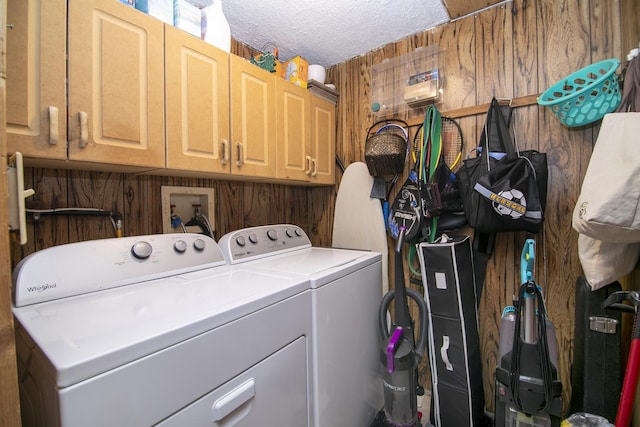 4618 W Hilltop Dr, Kankakee, IL 60901 - laundry room with washing machine and clothes dryer, cabinet space, a textured ceiling, and wood walls