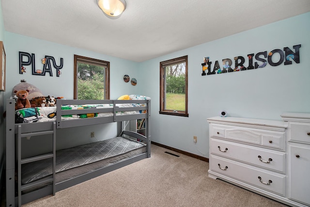 4618 W Hilltop Dr, Kankakee, IL 60901 - bedroom with multiple windows, light colored carpet, and baseboards