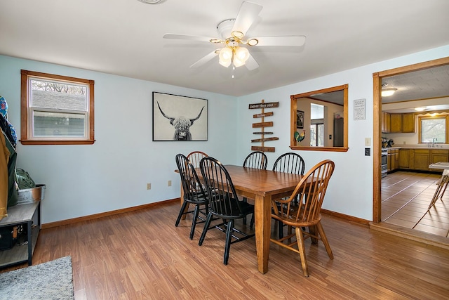 4618 W Hilltop Dr, Kankakee, IL 60901 - dining room featuring light wood-style flooring, ceiling fan, and baseboards