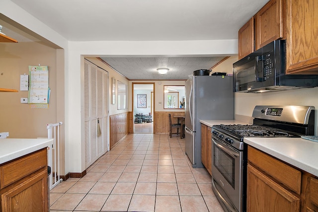 4618 W Hilltop Dr, Kankakee, IL 60901 - kitchen featuring appliances with stainless steel finishes, brown cabinets, light countertops, and light tile patterned flooring