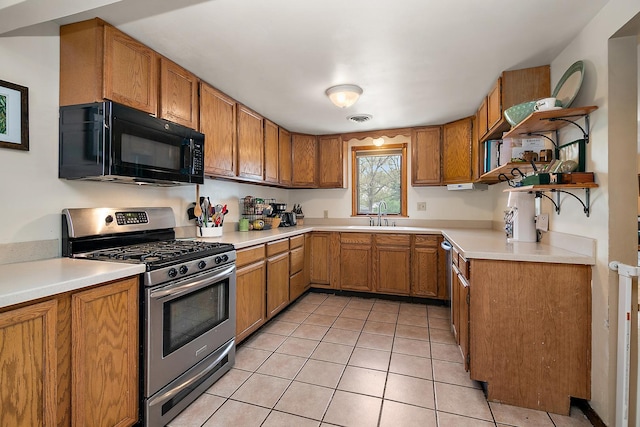 4618 W Hilltop Dr, Kankakee, IL 60901 - kitchen featuring stainless steel appliances, brown cabinets, open shelves, a sink, and light tile patterned flooring