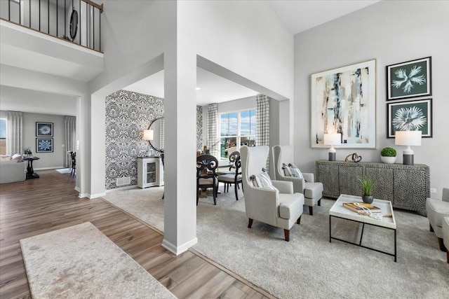10340 Amos St, Huntley, IL 60142 - living area featuring a towering ceiling, baseboards, and wood finished floors