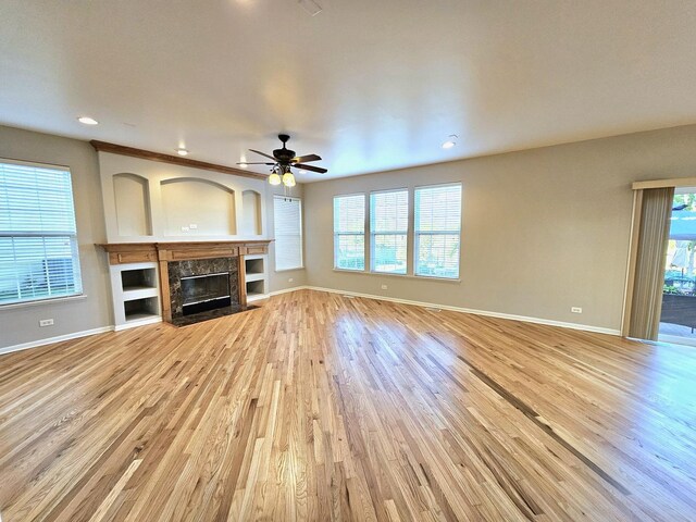 127 Charleston Ln, Gilberts, IL 60136 - unfurnished living room with light wood-style flooring, ceiling fan, a premium fireplace, and recessed lighting