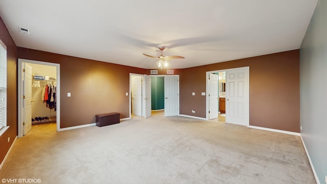 127 Charleston Ln, Gilberts, IL 60136 - unfurnished bedroom with a spacious closet, baseboards, light colored carpet, and ceiling fan