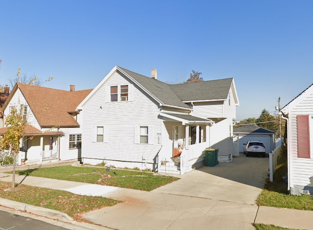 1028 Elizabeth St, Joliet, IL 60435 - view of front of house with a garage, an outbuilding, concrete driveway, and covered porch