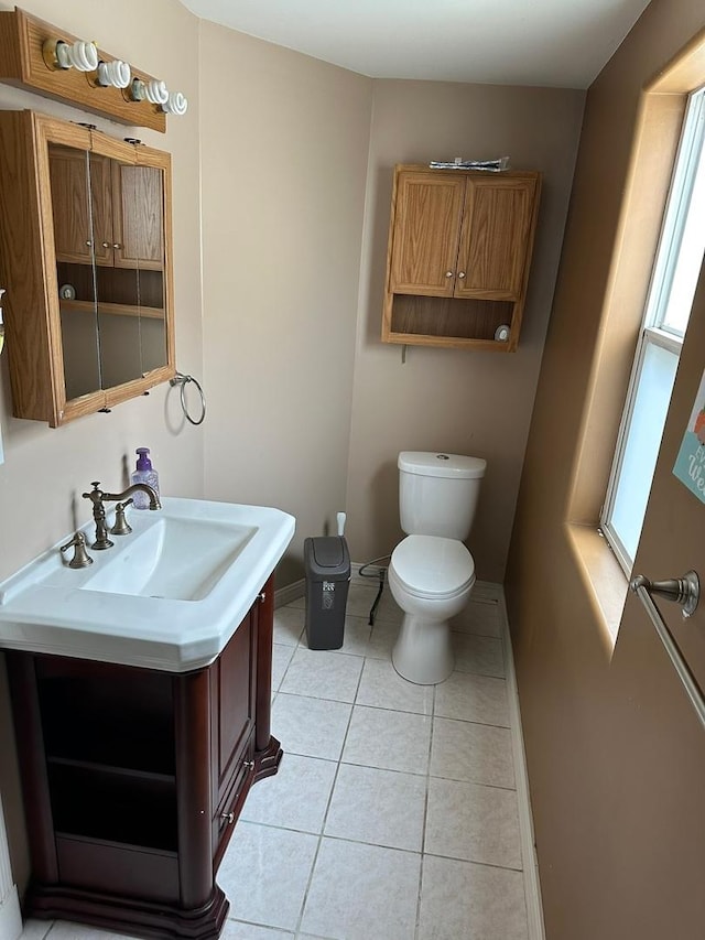 1028 Elizabeth St, Joliet, IL 60435 - bathroom with vanity, baseboards, tile patterned floors, and toilet