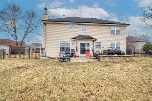 back of property featuring heating fuel, a lawn, a patio area, fence, and a chimney