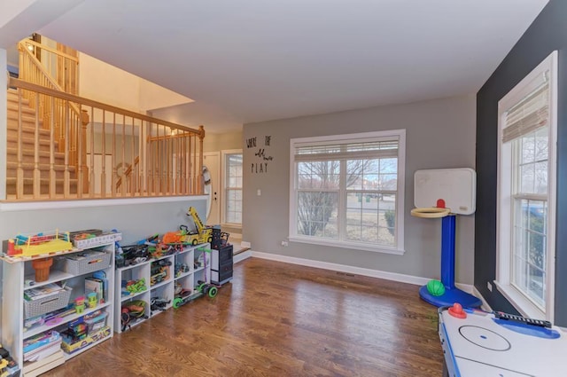 rec room featuring wood finished floors, baseboards, and a healthy amount of sunlight