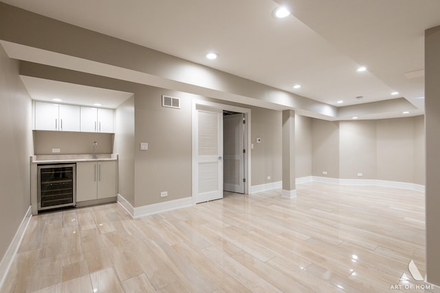 7902 W 105th St, Palos Hills, IL 60465 - bar with beverage cooler, indoor wet bar, light wood-type flooring, a sink, and visible vents