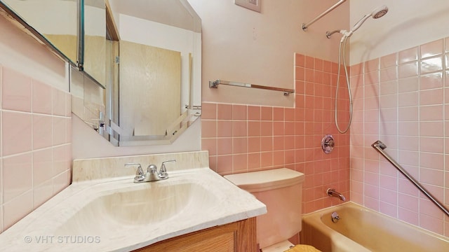 full bathroom with tile walls, vanity, toilet, and bathing tub / shower combination