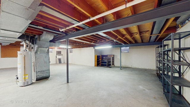 unfinished basement featuring heating unit and water heater