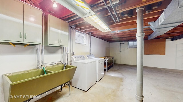 laundry room with a sink, cabinet space, and washer and dryer