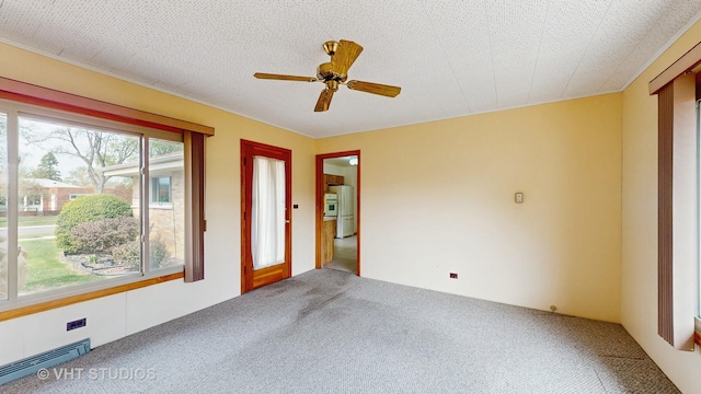 carpeted spare room featuring ceiling fan and visible vents