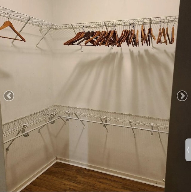 laundry area with light wood-style floors, stacked washer / drying machine, and laundry area