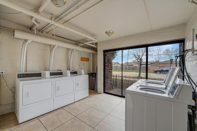 7117 W 93rd St Unit 102, Oak Lawn, IL 60453 - shared laundry area with independent washer and dryer, concrete block wall, and light tile patterned flooring