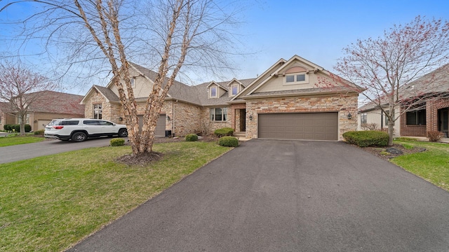 view of front facade with a front lawn, aphalt driveway, and stone siding