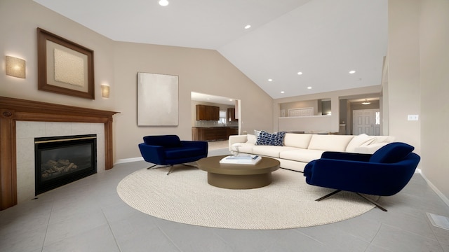 living room featuring recessed lighting, baseboards, vaulted ceiling, and tile patterned flooring