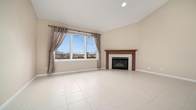 unfurnished living room with baseboards, a fireplace, recessed lighting, and lofted ceiling