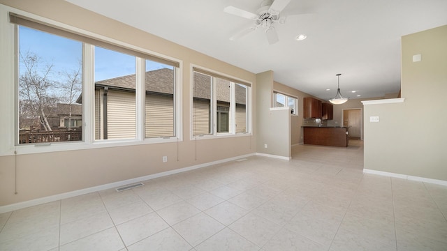 interior space featuring light tile patterned flooring, recessed lighting, baseboards, a ceiling fan, and visible vents