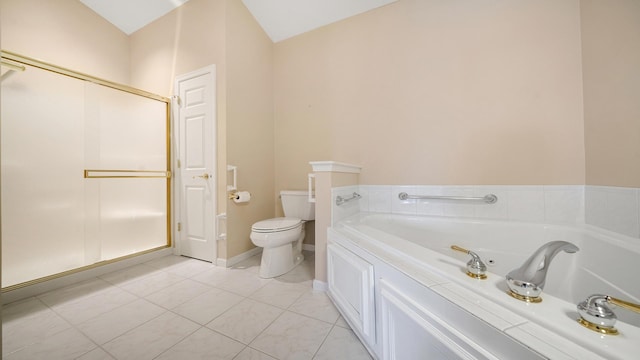 bathroom featuring tile patterned floors, a stall shower, a garden tub, and toilet