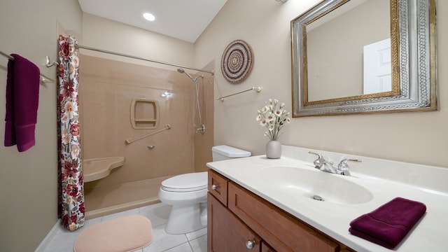 bathroom with vanity, tile patterned floors, toilet, and a shower