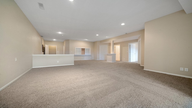 unfurnished living room featuring baseboards, carpet flooring, recessed lighting, and visible vents