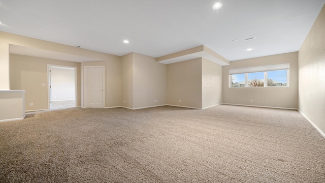 carpeted spare room featuring baseboards and recessed lighting