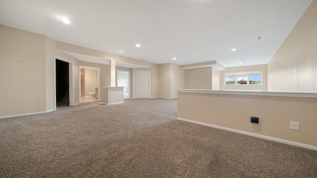 spare room with baseboards, light carpet, and recessed lighting