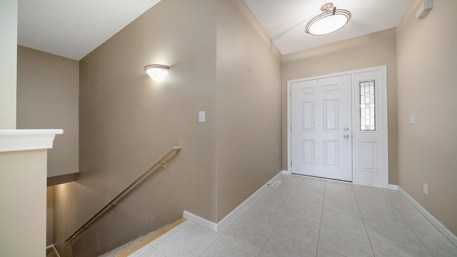 tiled foyer entrance with baseboards